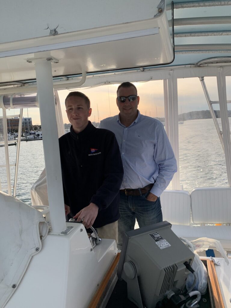 2 men driving a sportfishing Yacht